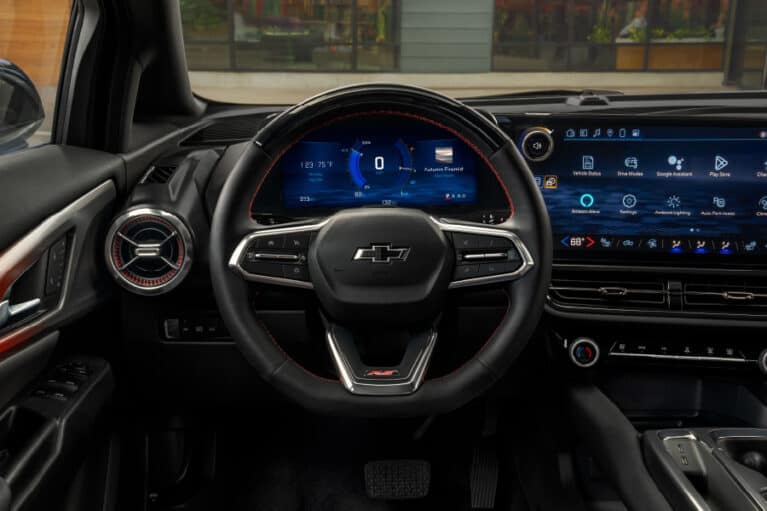 Interior view of a Chevrolet car showcasing a modern dashboard, digital instrument cluster, and a multifunction steering wheel, highlighting advanced technology features.